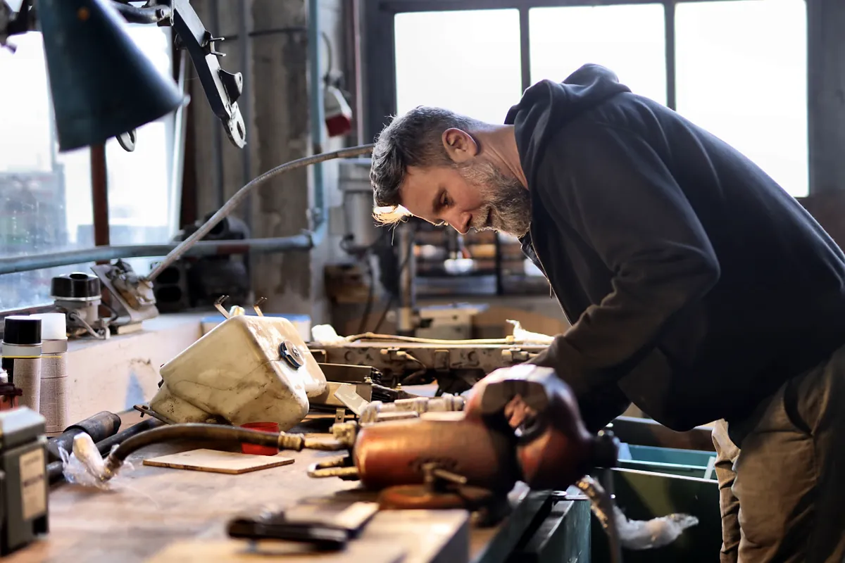 Experienced owner working at the bench in his machine shop